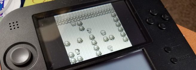 A Nintendo 2DS playing Pokémon Red